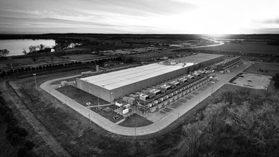 Black and white aerial view of a data centre as the sun sets