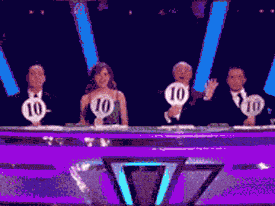 Strictly Come Dancing judges all holding up score paddles with 10 on